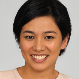 Joyful asian young-adult female with medium  black hair and brown eyes