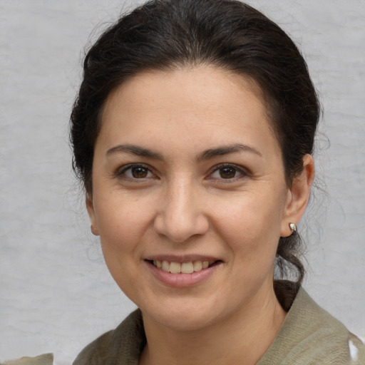 Joyful white young-adult female with medium  brown hair and brown eyes