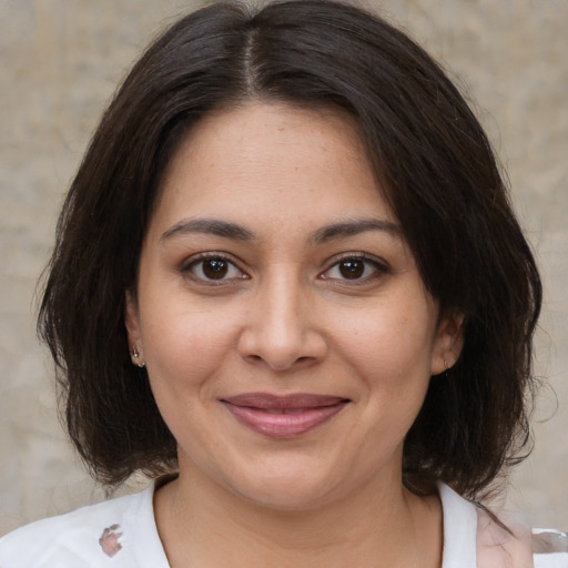 Joyful white young-adult female with medium  brown hair and brown eyes