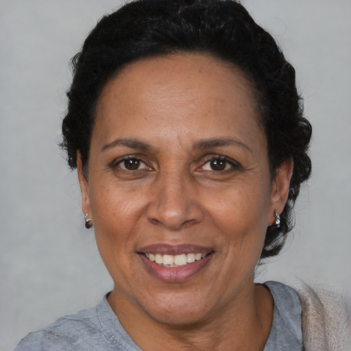 Joyful black adult female with short  black hair and brown eyes