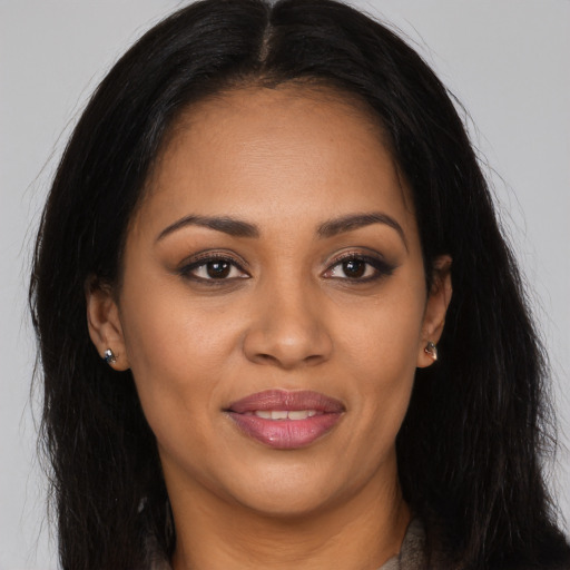 Joyful latino young-adult female with long  brown hair and brown eyes