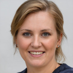 Joyful white young-adult female with medium  brown hair and blue eyes