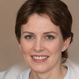 Joyful white adult female with medium  brown hair and grey eyes