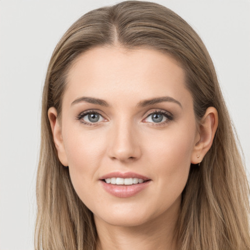 Joyful white young-adult female with long  brown hair and grey eyes