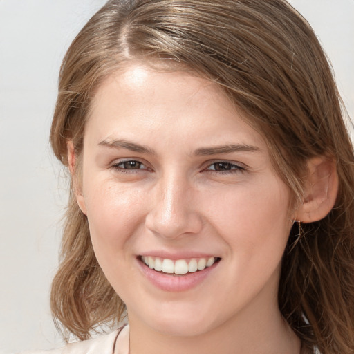 Joyful white young-adult female with long  brown hair and grey eyes