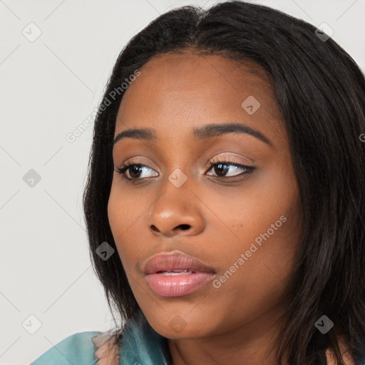 Joyful black young-adult female with long  black hair and brown eyes