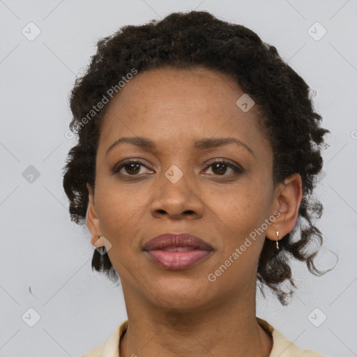 Joyful black adult female with short  brown hair and brown eyes