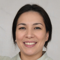 Joyful white young-adult female with medium  brown hair and brown eyes