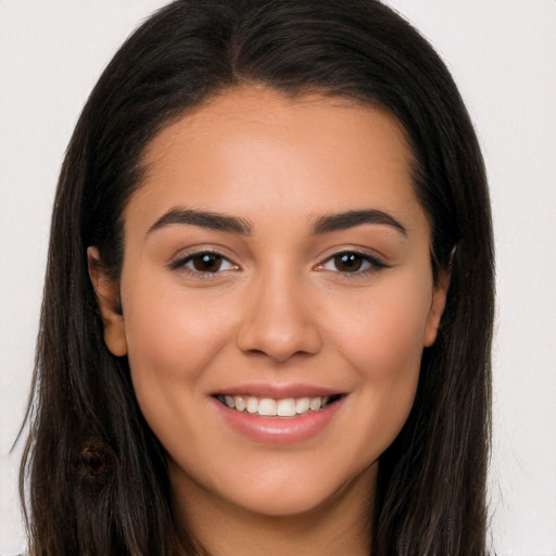 Joyful latino young-adult female with long  brown hair and brown eyes