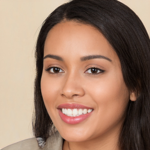 Joyful latino young-adult female with long  black hair and brown eyes