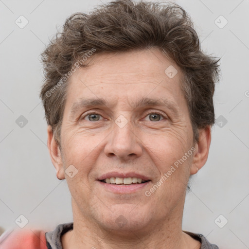 Joyful white adult male with short  brown hair and grey eyes