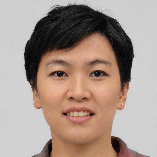 Joyful asian young-adult female with short  black hair and brown eyes