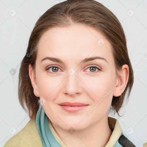 Joyful white young-adult female with medium  brown hair and blue eyes