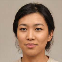 Joyful asian young-adult female with medium  brown hair and brown eyes