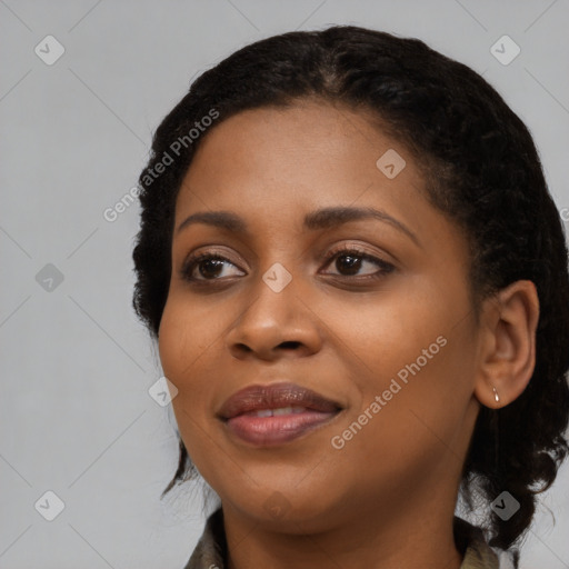 Joyful black young-adult female with long  black hair and brown eyes