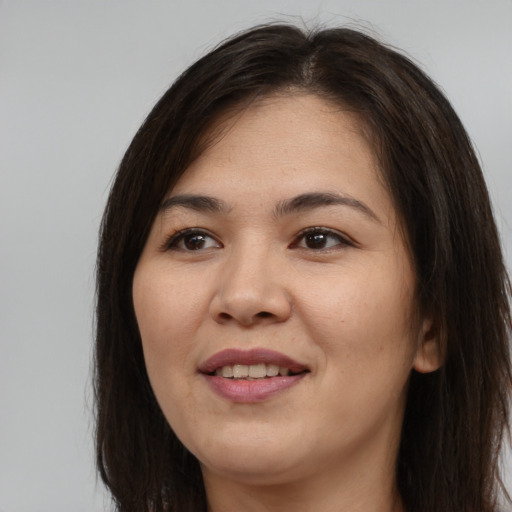 Joyful asian young-adult female with long  brown hair and brown eyes