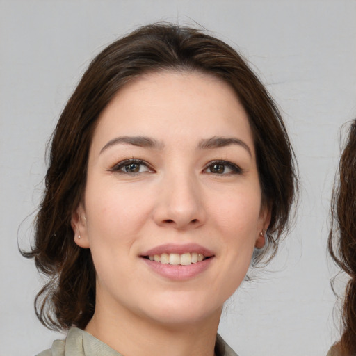 Joyful white young-adult female with medium  brown hair and brown eyes