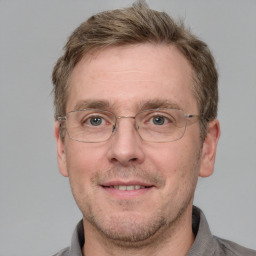 Joyful white adult male with short  brown hair and grey eyes