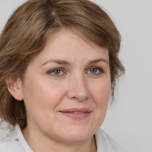 Joyful white adult female with medium  brown hair and brown eyes