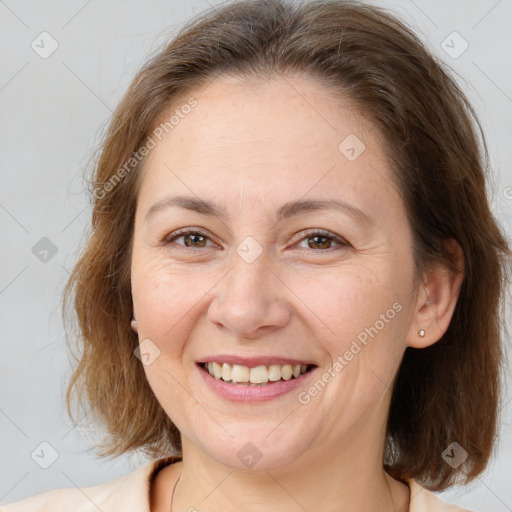 Joyful white adult female with medium  brown hair and brown eyes