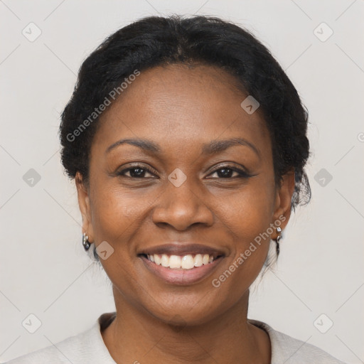 Joyful black adult female with short  black hair and brown eyes