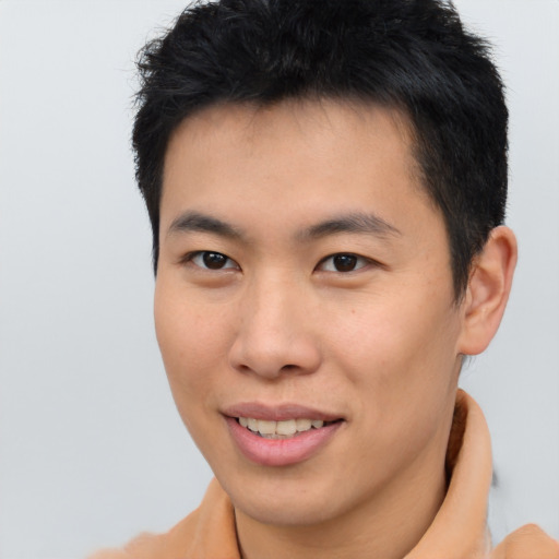 Joyful asian young-adult male with short  brown hair and brown eyes
