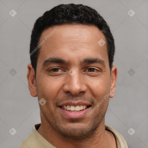 Joyful latino young-adult male with short  black hair and brown eyes