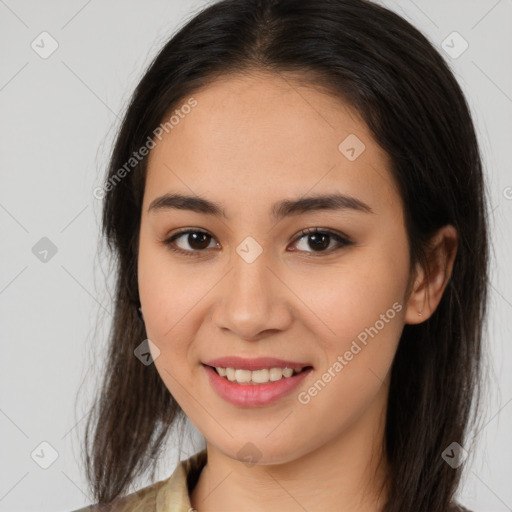 Joyful latino young-adult female with long  brown hair and brown eyes