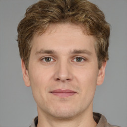 Joyful white adult male with short  brown hair and grey eyes