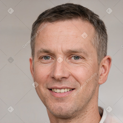 Joyful white adult male with short  brown hair and brown eyes