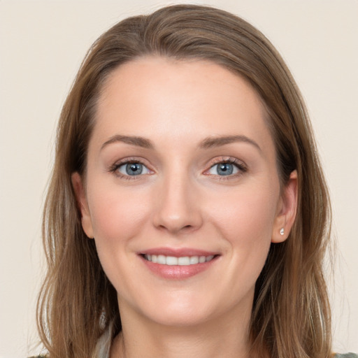 Joyful white young-adult female with long  brown hair and grey eyes