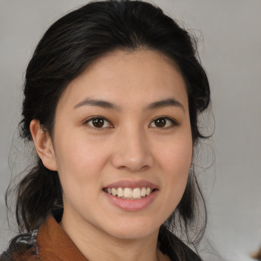 Joyful white young-adult female with medium  black hair and brown eyes