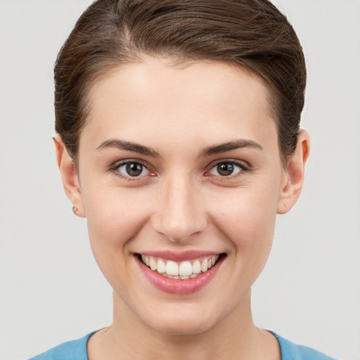 Joyful white young-adult female with short  brown hair and brown eyes