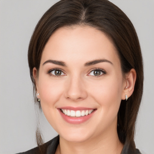 Joyful white young-adult female with medium  brown hair and brown eyes