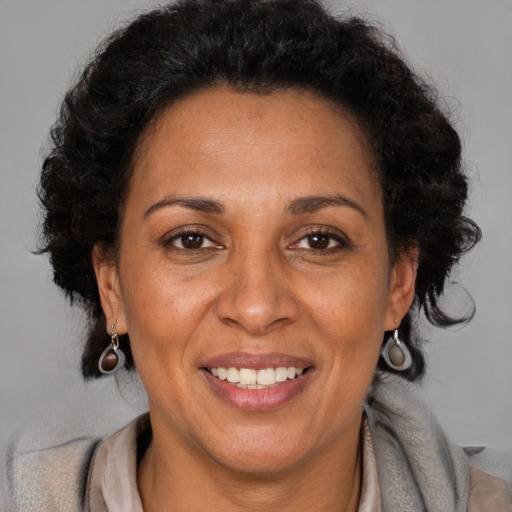 Joyful latino adult female with short  brown hair and brown eyes