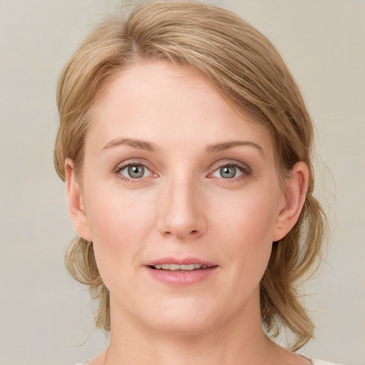 Joyful white young-adult female with medium  brown hair and blue eyes