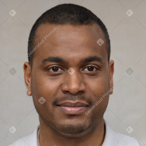 Joyful black young-adult male with short  brown hair and brown eyes