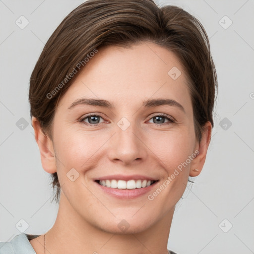 Joyful white young-adult female with short  brown hair and grey eyes