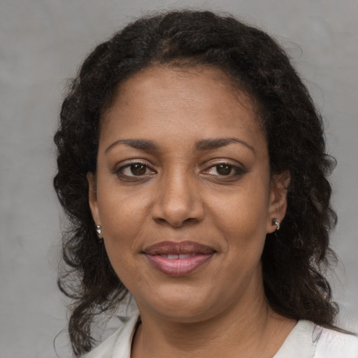 Joyful black young-adult female with medium  brown hair and brown eyes