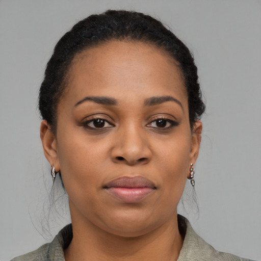 Joyful black young-adult female with medium  black hair and brown eyes