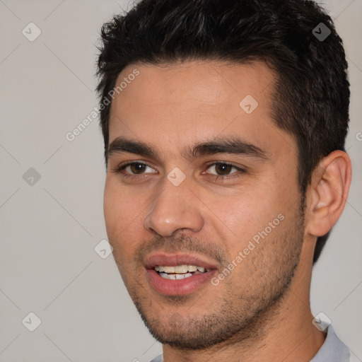 Joyful white young-adult male with short  black hair and brown eyes