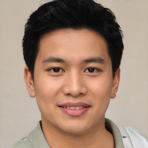 Joyful asian young-adult male with short  black hair and brown eyes