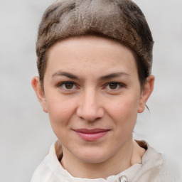 Joyful white young-adult female with short  brown hair and grey eyes