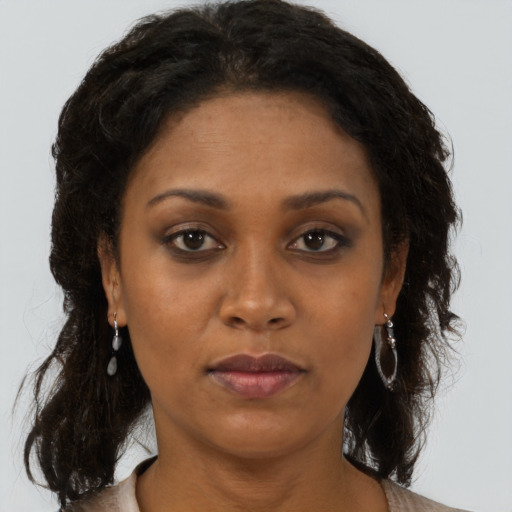 Neutral black adult female with long  brown hair and brown eyes