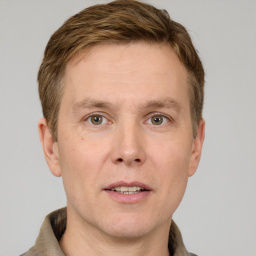 Joyful white adult male with short  brown hair and grey eyes