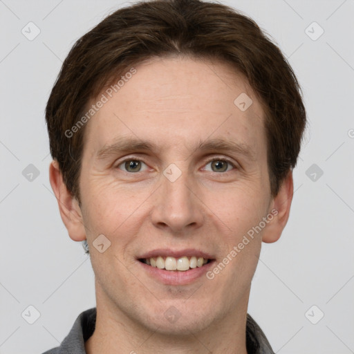 Joyful white adult male with short  brown hair and grey eyes