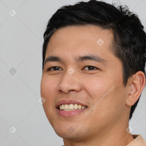 Joyful asian young-adult male with short  brown hair and brown eyes