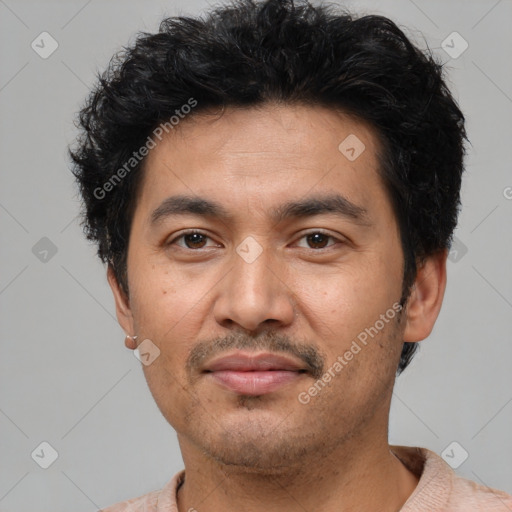 Joyful latino adult male with short  black hair and brown eyes