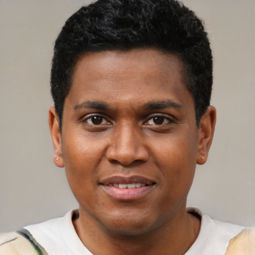 Joyful black young-adult male with short  black hair and brown eyes