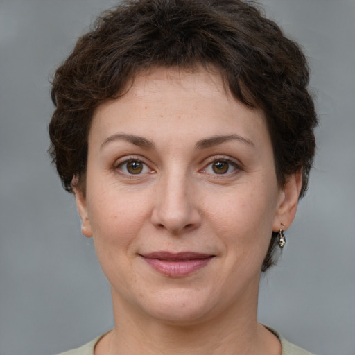 Joyful white adult female with short  brown hair and grey eyes